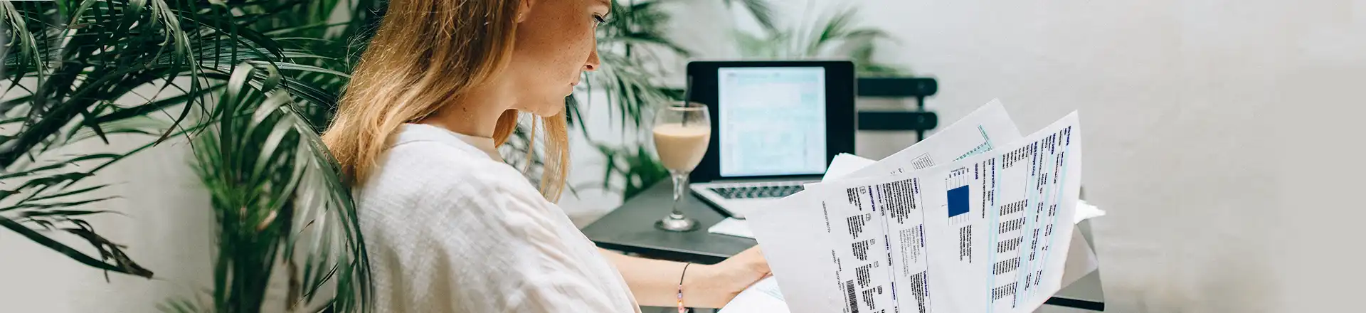 woman sitting in chair reading energy bill