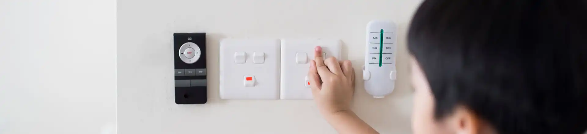 child touching light switch