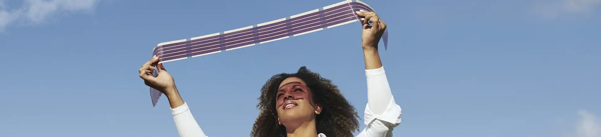 women holding up a film strip to sun